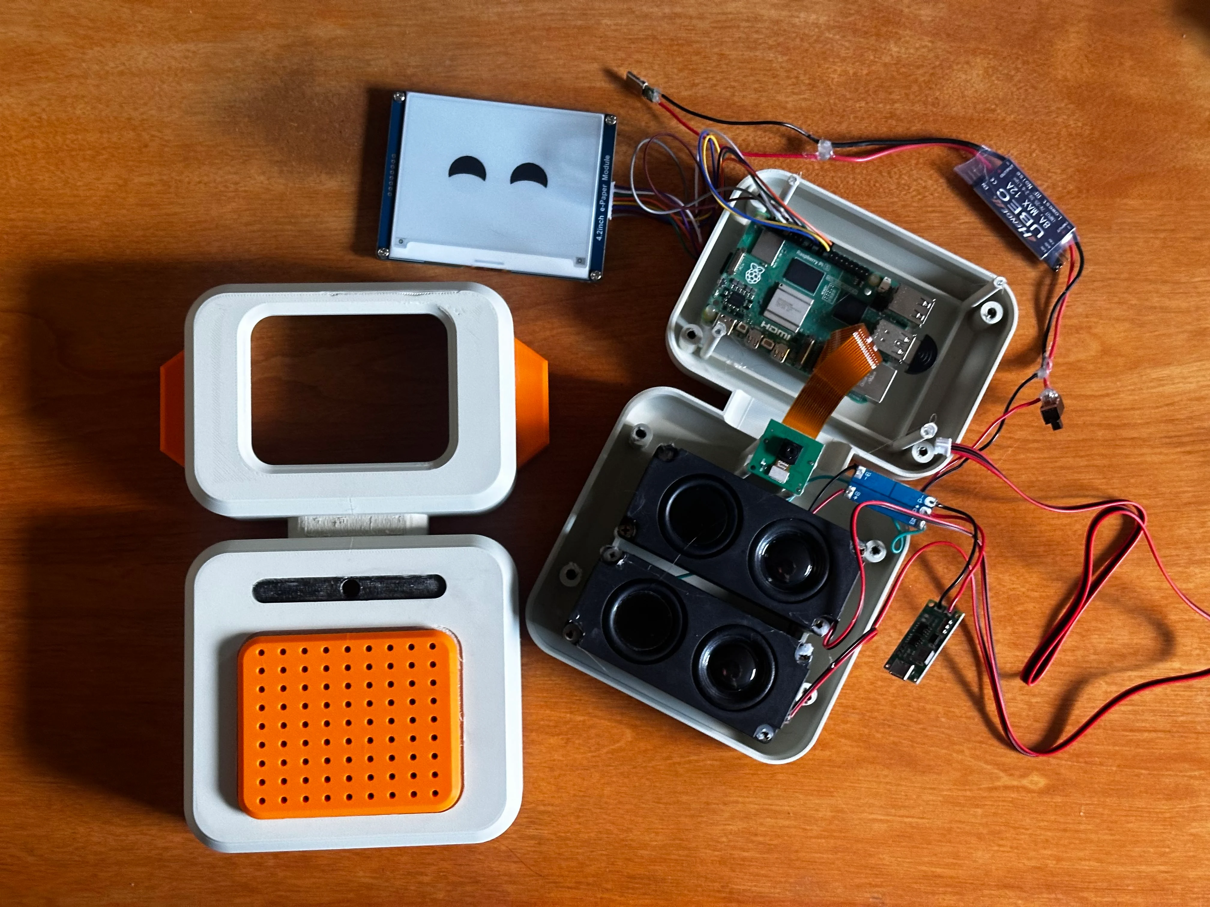 Zero shell, E-Ink display, and Raspberry Pi 5 laid out on a workbench